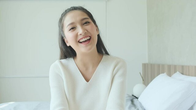 happy young asian attractive female casual cloth positive video call conversation with friend or family  smiling looking at camera,Head shot portrait of cheerful young woman
