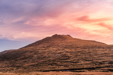 Dramatic sunset, setting sun highlighting Slievebeg Mountain peak in Mourne Mountains, County Down, Northern Ireland