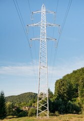 A transmission tower or power tower. High voltage tower against clear blue sky.