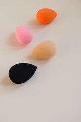 Closeup photo of colorful cosmetic beauty blenders on a white background. Make up sponge