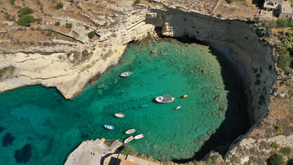 Aerial drone photo of beautiful fishing seaside village of Mezapos with crystal clear emerald beach in Mani Peninsula, Lakonia prefecture, Peloponnese, Greece