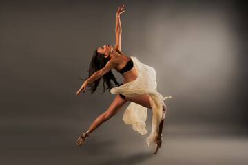 Fototapeta na wymiar Ballet dancer with black lingerie and gauze doing dance pose
