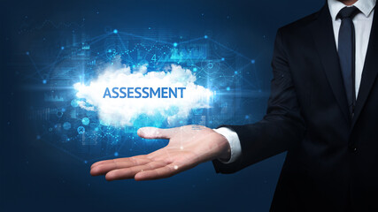 Hand of Businessman holding ASSESSMENT inscription, successful business concept