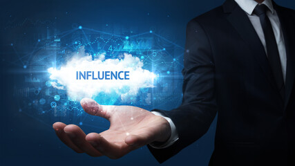 Hand of Businessman holding INFLUENCE inscription, successful business concept