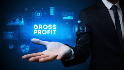 Hand of Businessman holding GROSS PROFIT inscription, business success concept