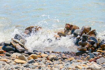 pebbles and stones on the beach. waves and splashes on the shore