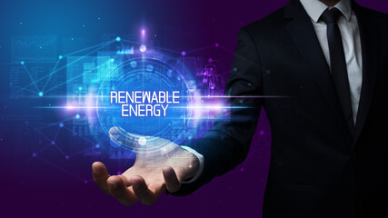 Man hand holding RENEWABLE ENERGY inscription, technology concept
