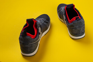 Insulated sneakers on a yellow background. Warm shoes concept.