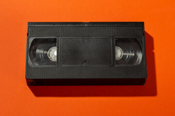 A videotape without a cover on an orange background.