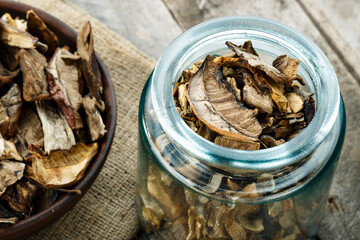 dried mushrooms in a jar and bowl