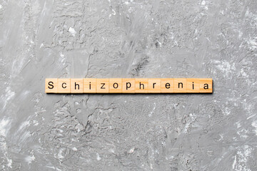 schizophrenia word written on wood block. schizophrenia text on table, concept