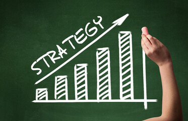 Hand drawing STRATEGY inscription with white chalk on blackboard, business concept
