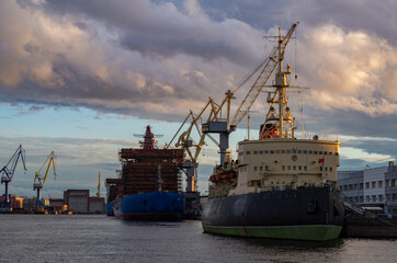 Fototapeta premium Shipyards at sunset in autumn.Shipbuilding in Russia.