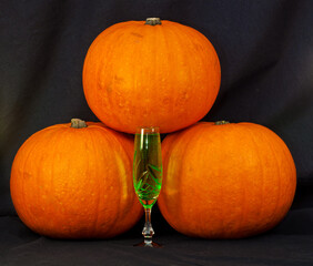 A trio of pumpkins against a black background