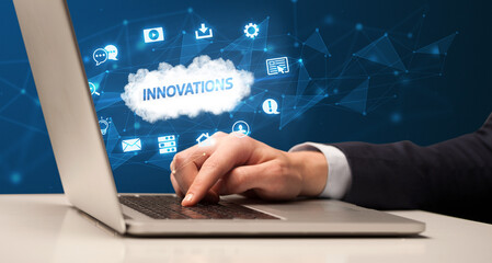 Businessman working on laptop with INNOVATIONS inscription, modern technology concept