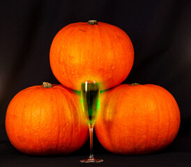 A trio of pumpkins against a black background