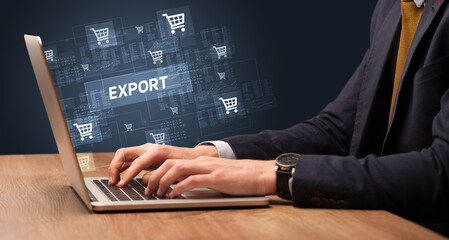 Obraz na płótnie Canvas Businessman working on laptop with EXPORT inscription, online shopping concept