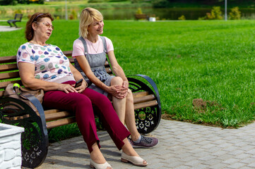 Two nice Mature women relax in a Park.