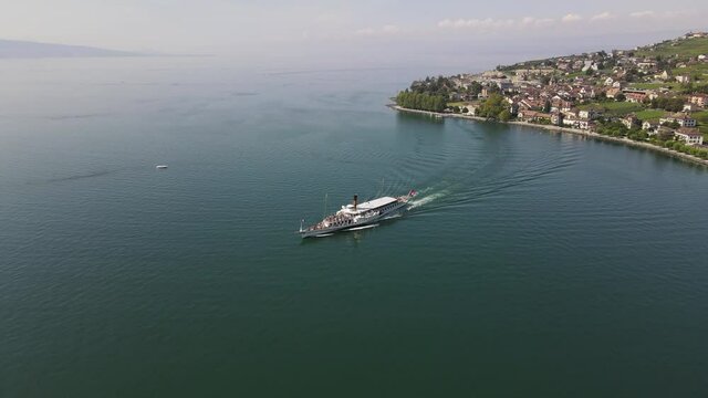 Steam boat leaving Cully harbor in Lavaux, Switzerland.