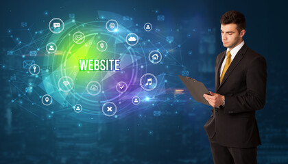 Businessman thinking in front of technology related icons and WEBSITE inscription, modern technology concept