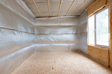 Thermal insulation of a country house, vapor barrier film made of reflective polyethylene foam...