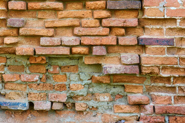Background of an Old red brick wall. Destruction and preservation of ancient historical buildings.