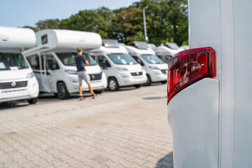 Line of Brand New Camper Vans Motorhomes Awaiting Clients on Dealership Sales Lot. Recreational...