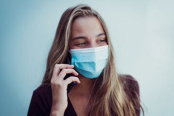 Girl Wearing mask due coronavirus in a phone call