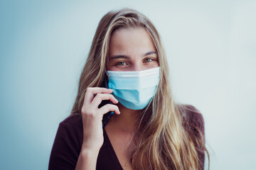 Girl Wearing mask due coronavirus speaks at phone
