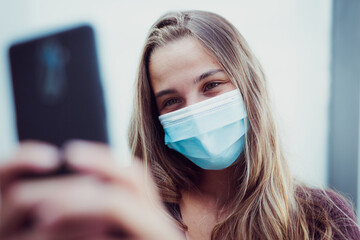 Girl Wearing mask due coronavirus makes selfie