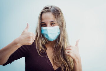 Girl Wearing mask due coronavirus Thumbs up