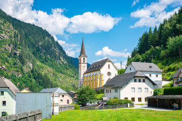 Fototapeta na wymiar Traditional austrian scene with a church in the centre of a village
