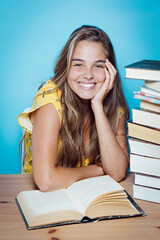 Young beautiful woman happy with books