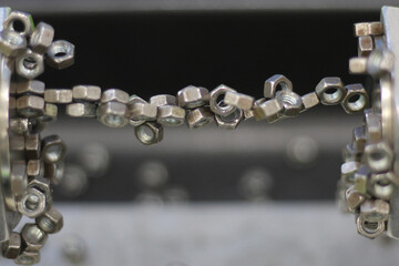 Studying the properties of the magnetic field in school classes using the example of small steel nuts.