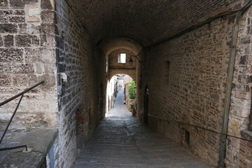 alley with arch in the medieval town of gubbio umbria italy