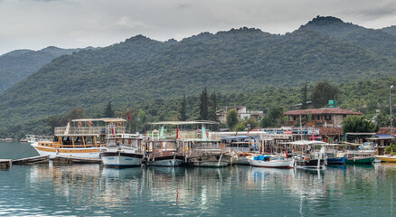 Fototapeta na wymiar Kalekoy village harbour on Kekova island with boats and small ships docked on the water