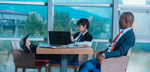 Multi-ethnic business people having discussion at conference table in office