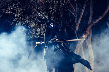 Portrait of grim reaper, the angel of death ( Azrael ) lurking through the woods at night...
