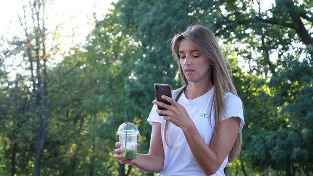 the girl takes pictures of the boiler in the park and then uploads the photo to social networks such as Instagram, and in anticipation awaits a response to her post