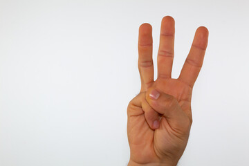 Naklejka premium close up of a man's hand communicating with sign language, letters of the alphabet, on a white background