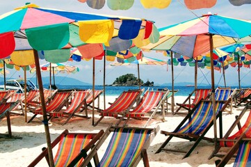 Colourful beach umbrellas and chairs on Phuket beach, Thailand 