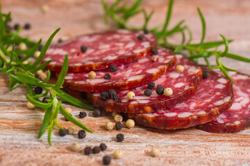 salami slices with pepper and rosemary