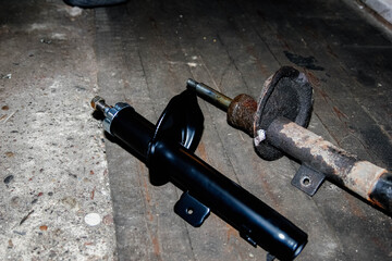 old rusty faulty car shock absorber. suspension repair.