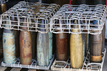 Rusty artillery shells in rack