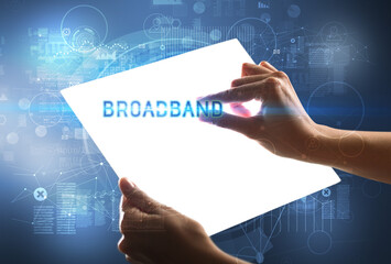 Hand holdig futuristic tablet with BROADBAND inscription, new technology concept