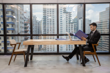 young man working laptop. Business men working on laptop computer at office.