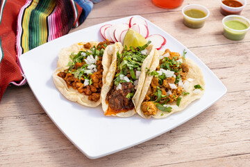 Fast and cheap Mexican street tacos. Carne asada, barbacoa, and chicken served on small and simple corn tortillas.