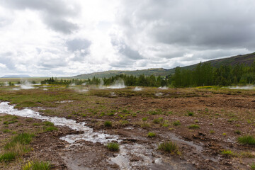 ground smoking with water in the foreground on a very cloudy day