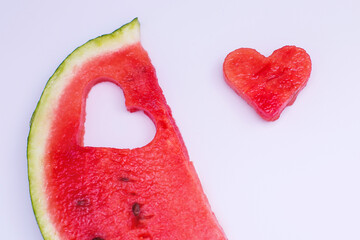 Naklejka na ściany i meble Juicy bright red watermelon on a white isolated background, watermelon in the shape of a heart
