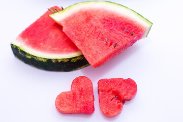 Juicy bright red watermelon on a white isolated background, watermelon in the shape of a heart